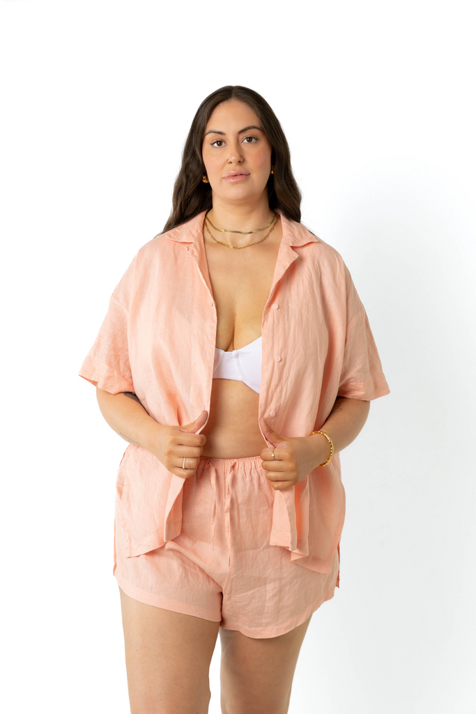 model wears size 18/20 linen shirt and shorts set in peach