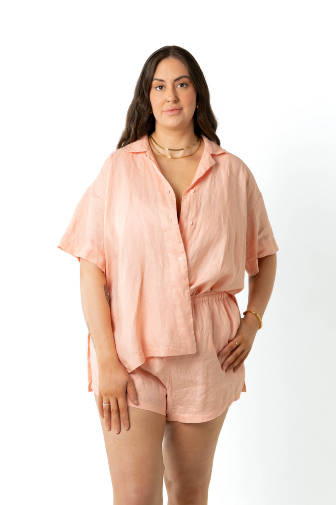 model wears size 18/20 linen shirt and shorts set in peach